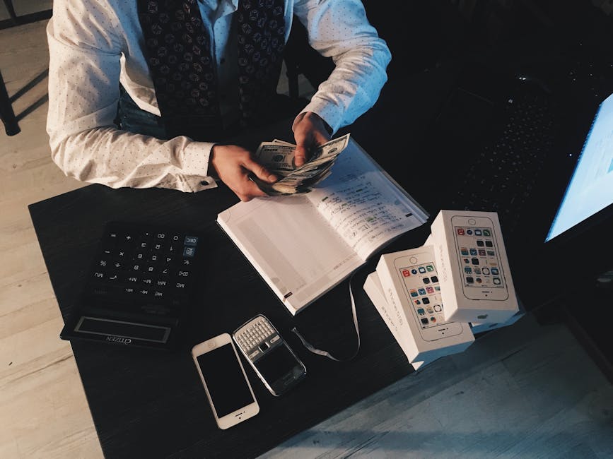 Businessman organizing finances with tech devices