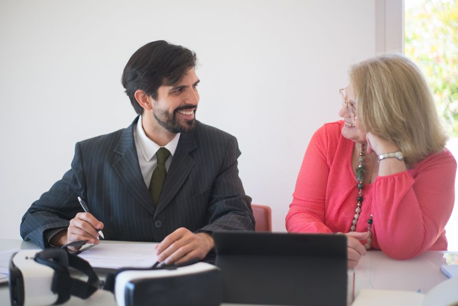 Two professionals signing a contract with joyful expressions, symbolizing a successful business deal.